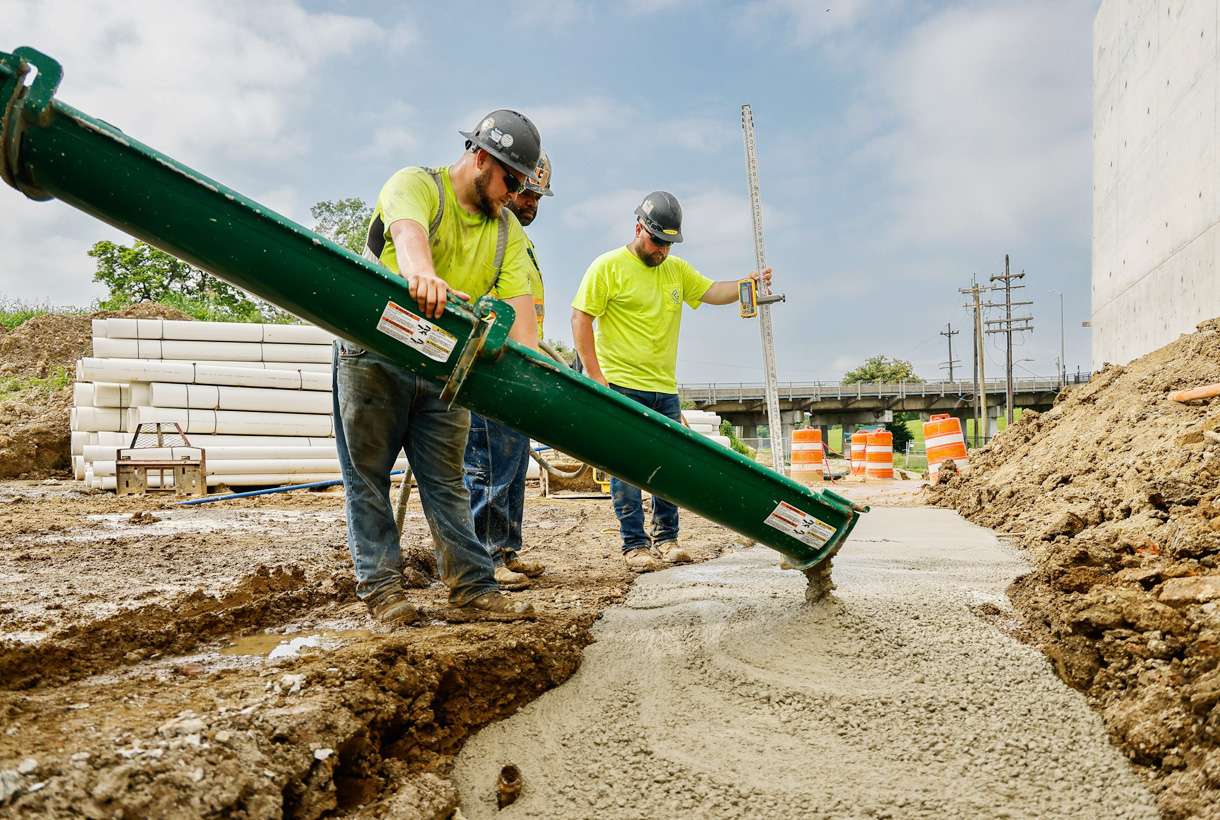 Construction workers pouring concrete footers